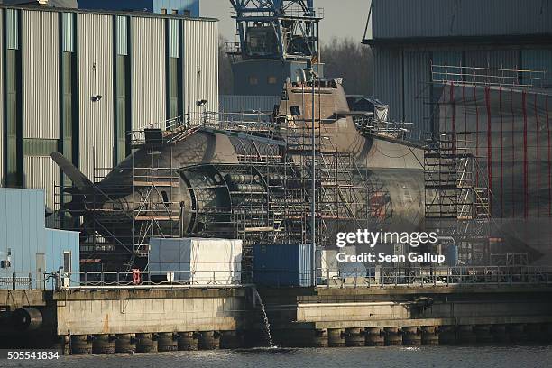 Military submarine stands in dry dock under construction at the ThyssenKrupp Marine Systems GmbH shipyard on January 18, 2016 in Kiel, Germany. The...