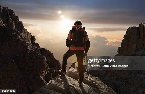 lone climber on a mountain at sunrise - climber imagens e fotografias de stock