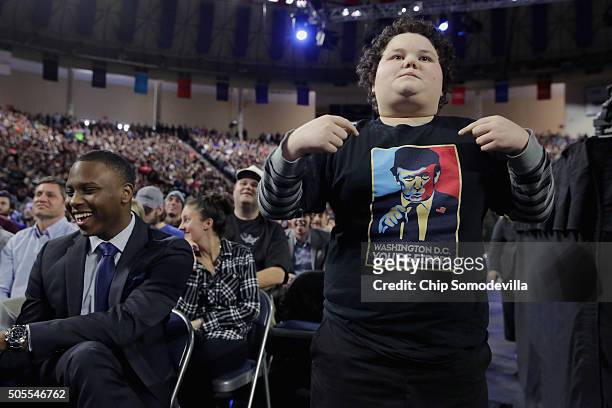 Boy stands up to cheer for Republican presidential candidate Donald Trump as he delivers the convocation at the Vines Center on the campus of Liberty...