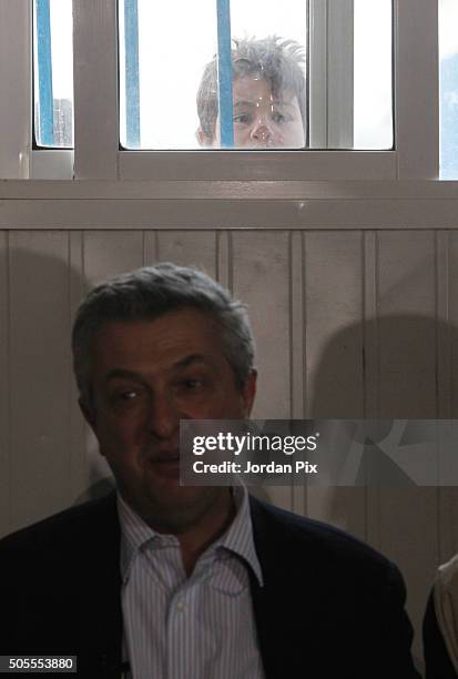Young boy peers through a window as Filippo Granti, the new UNHCR High Commissioner visits the Zaatari camp for Syrian refugees on January 18, 2016...