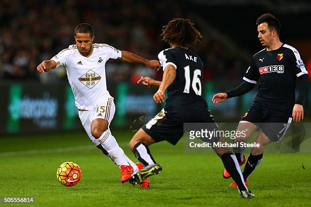 Wayne Routledge of Swansea City runs with the ball at Nathan Ake and Jose Manuel Jurado of Watford during the Barclays Premier League match between...