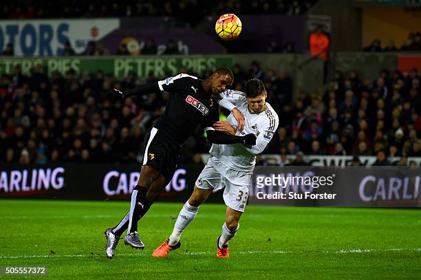 Odion Ighalo of Watford heads wide under pressure from Federico Fernandez of Swansea City during the Barclays Premier League match between Swansea...