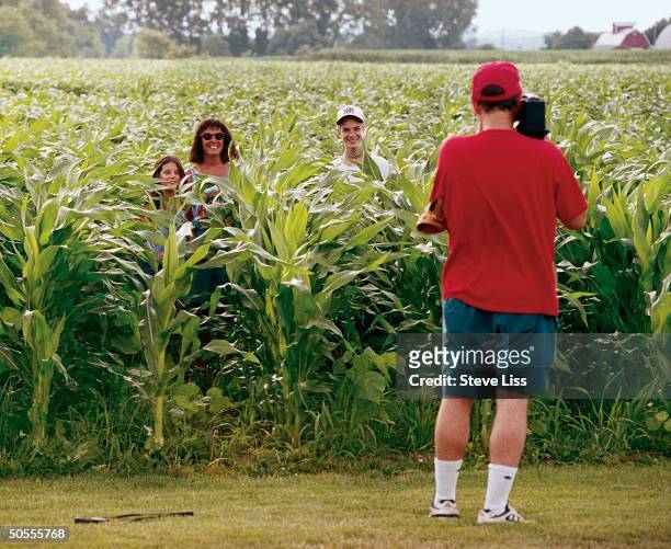 Visitor Bob Sigovich, daughter Dana, wife Jan and son John playing in the corn/baseball field co-owned by Rita and Al Ameskamp and Becky and Don...