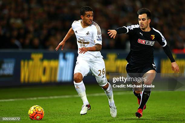 Kyle Naughton of Swansea City runs with the ball under pressure from Jose Manuel Jurado of Watford during the Barclays Premier League match between...