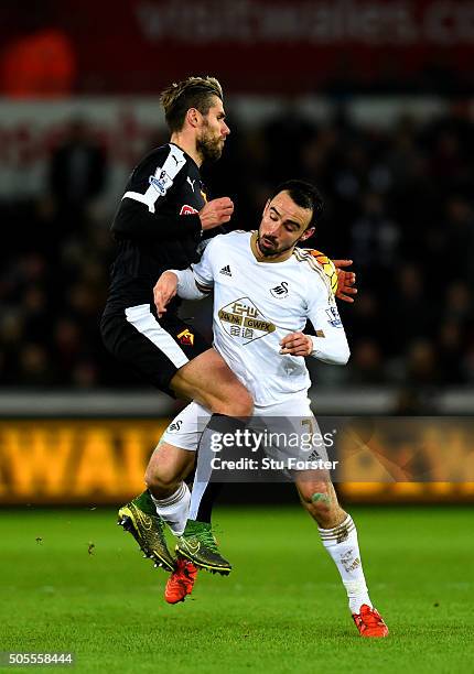 Valon Behrami of Watford jumps for the ball with Leon Britton of Swansea City during the Barclays Premier League match between Swansea City and...