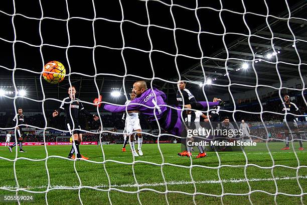 Heurelho Gomes of Watford dives in vain as Ashley Williams of Swansea City scores the opening goal during the Barclays Premier League match between...