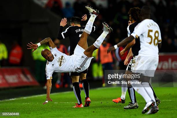 Andre Ayew of Swansea City clashes with Jose Manuel Jurado of Watford during the Barclays Premier League match between Swansea City and Watford at...