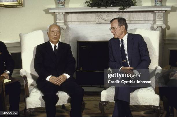 President George H. W. Bush meeting with Chinese Vice-Premier Wan Li, in Oval Office.