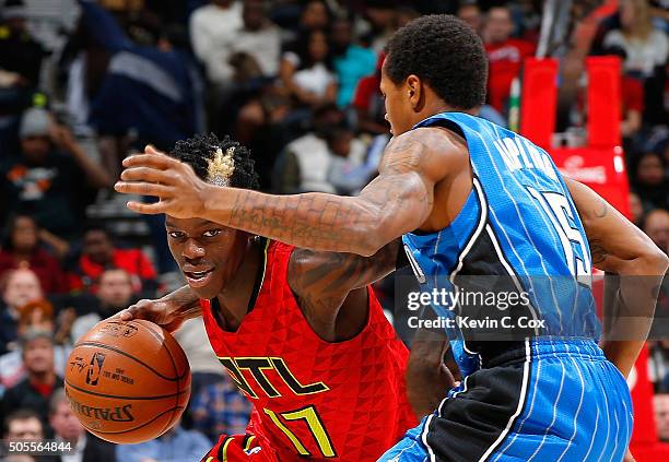 Dennis Schroder of the Atlanta Hawks drives against Keith Appling of the Orlando Magic at Philips Arena on January 18, 2016 in Atlanta, Georgia. NOTE...