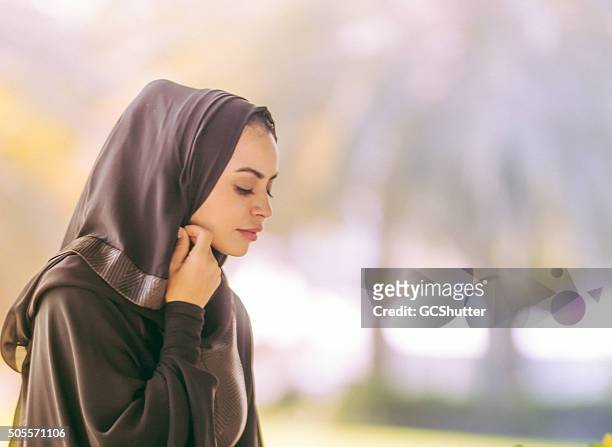 young beautiful arab girl covering her head - beautiful arabian girls stock pictures, royalty-free photos & images