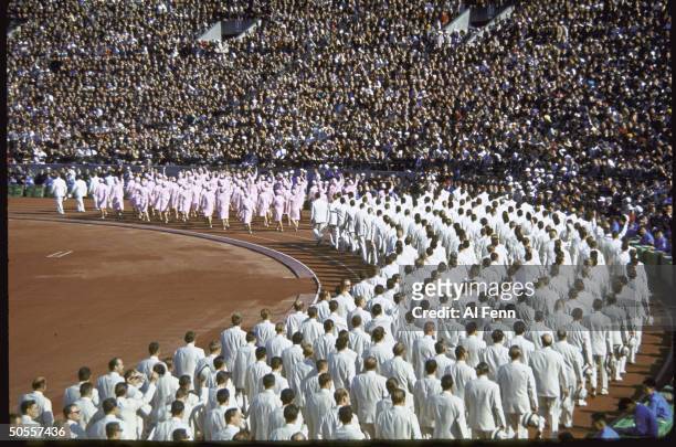 East and West German teams competing as 1 nation march together in National Stadium at the Summer Olympics.