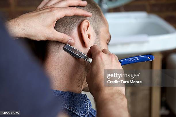 man getting hair cut with razor - barber shop imagens e fotografias de stock