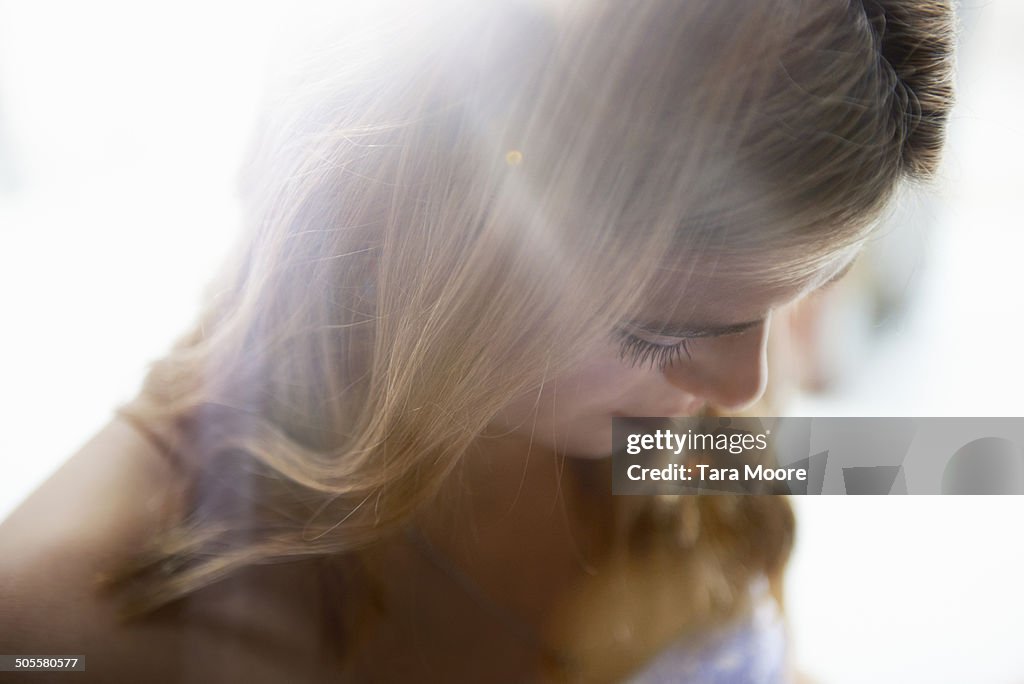 Beautiful woman standing in sunlight