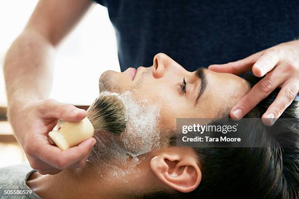 man at barber shop with shaving cream - scheerkwast stockfoto's en -beelden