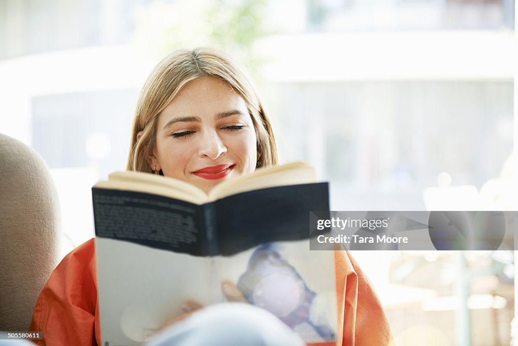 Woman smiling and reading book