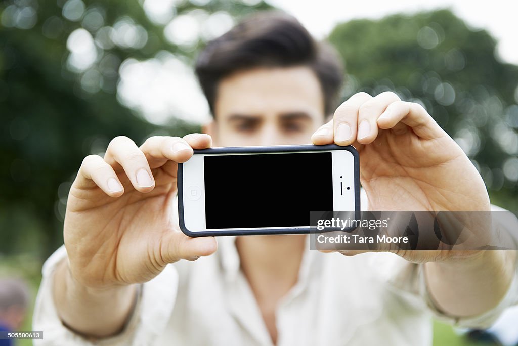 Man holding phone up to camera