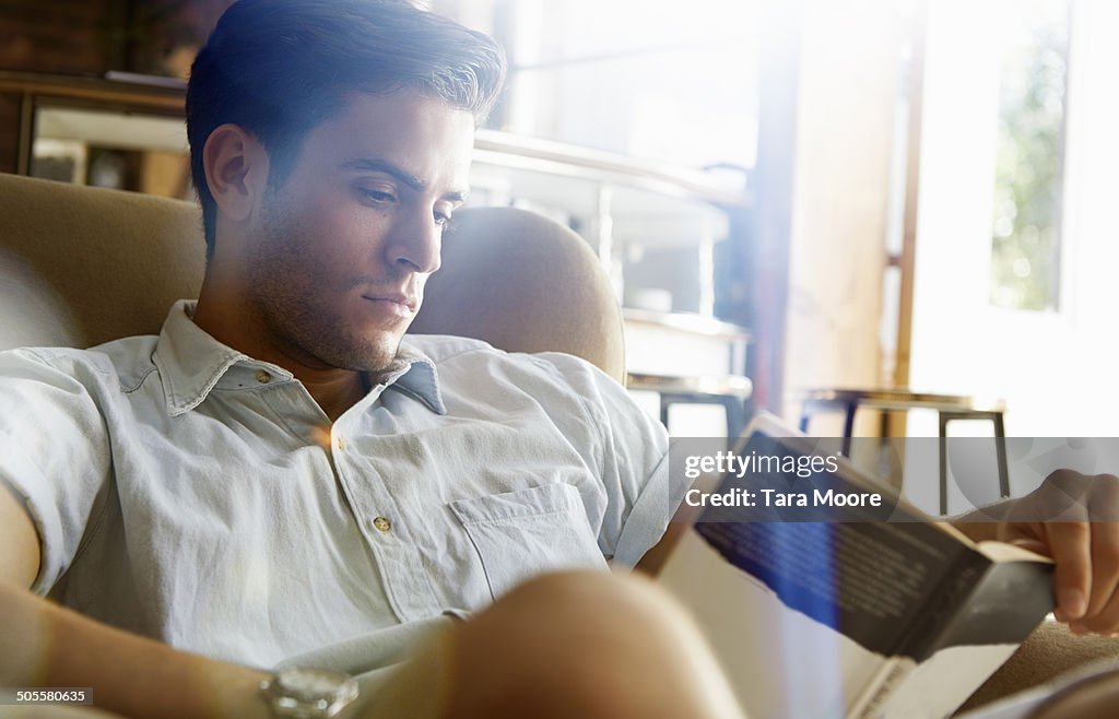Man reading book in cafe