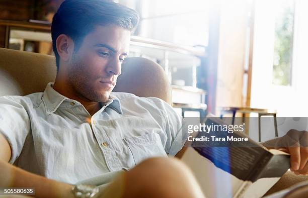 man reading book in cafe - handsome people stock pictures, royalty-free photos & images