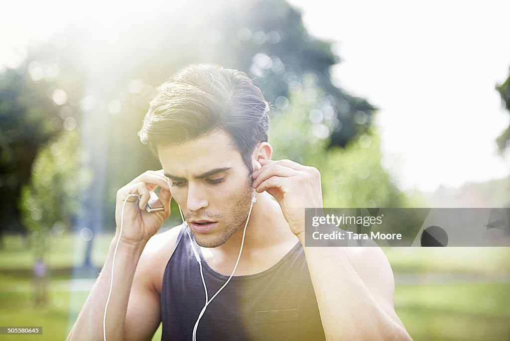 Sportsman listening to music in park