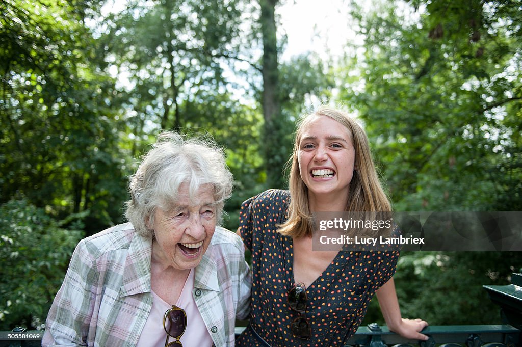 Senior (98) lady and young woman laughing in park