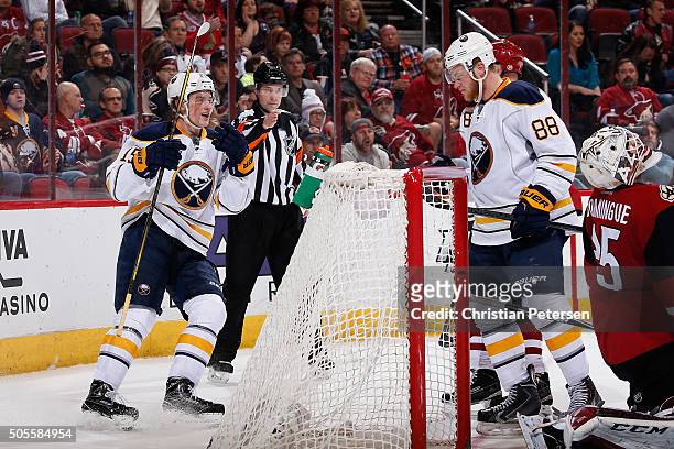 Jack Eichel and Jamie McGinn of the Buffalo Sabres celebrate after McGinn scored a second-period power-play goal past goaltender Louis Domingue of...