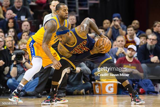 Andre Iguodala of the Golden State Warriors guards LeBron James of the Cleveland Cavaliers during the first half at Quicken Loans Arena on January...