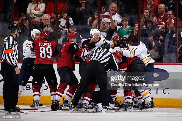 Shane Doan, Oliver Ekman-Larsson and Anthony Duclair of the Arizona Coyotes come together in a post game scrum with Sam Reinhart and Zach Bogosian of...