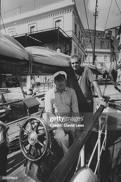Prince Juan Carlos w his father of their yacht, during the Olympics.