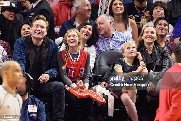 Conan O'Brien, Neve O'Brien, Beckett O'Brien and Liza Powel attend a basketball game between the Houston Rockets and the Los Angeles Clippers at...