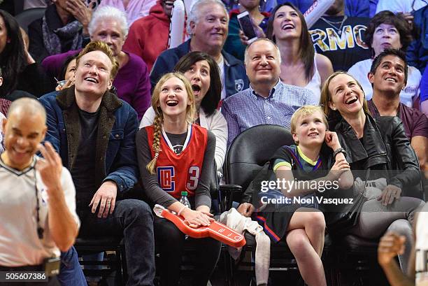 Conan O'Brien, Neve O'Brien, Beckett O'Brien and Liza Powel attend a basketball game between the Houston Rockets and the Los Angeles Clippers at...