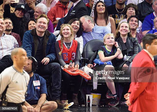 Conan O'Brien, Neve O'Brien, Beckett O'Brien and Liza Powel attend a basketball game between the Houston Rockets and the Los Angeles Clippers at...