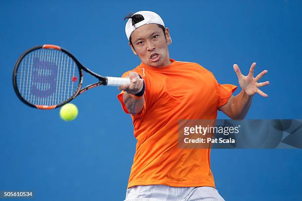 Tatsuma Ito of Japan plays a forehand in his first round match against Radek Stepanek of Czech Republic during day two of the 2016 Australian Open at...