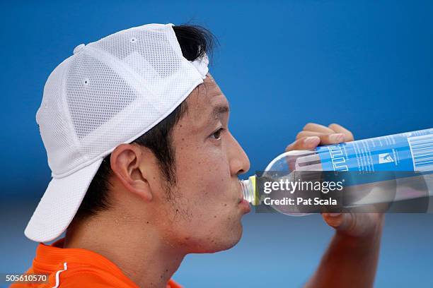 Tatsuma Ito of Japan takes a drink in between games in his first round match against Radek Stepanek of Czech Republic during day two of the 2016...