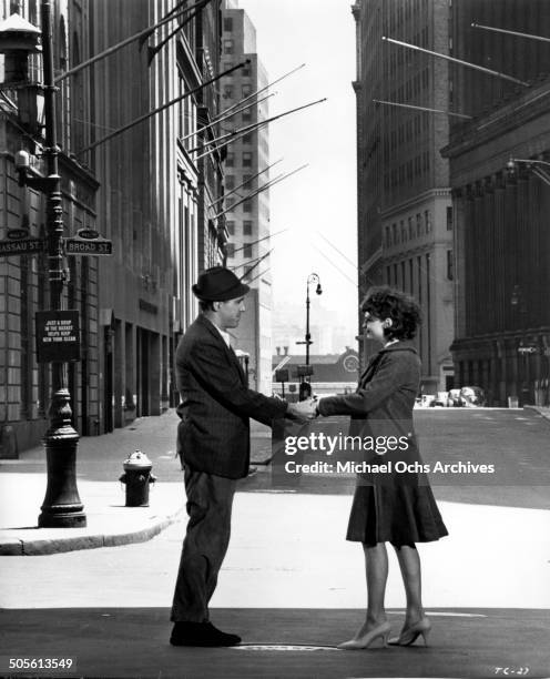 Jason Robards and Barbara Harris hold hands on a city street in a scene from the movie "A Thousand Clowns", circa 1965.