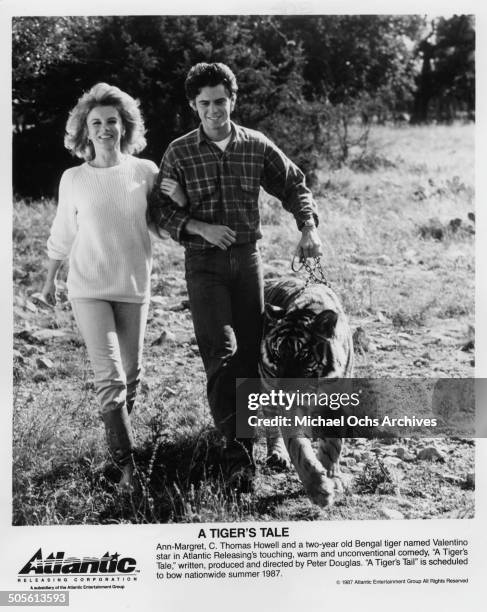 Ann-Margret walks with C. Thomas Howell and two year old Bengal tiger Valentino in a scene from the movie "A Tiger's Tale" circa 1987.