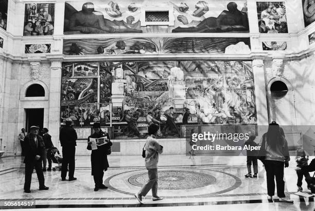 Visitors viewing one of the Detroit Industry Murals, a series of frescoes by Mexican painter Diego Rivera, at the Detroit Institute of Arts, Detroit,...