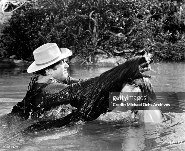 Dean Martin drowns Rosemary Forsyth in a scene from the Universal Studio movie "Texas Across the River", circa 1966.