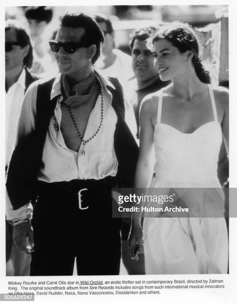 Mickey Rourke and Carre Otis walk in a scene from the movie "Wild Orchid" circa 1989.