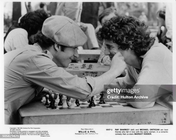 Ray Sharkey and Michael Ontkean talk over a game of chess in a scene from the 20th Century Fox movie "Willie & Phil" circa 1980.