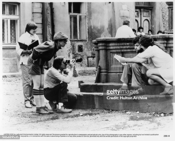 Barbra Streisand stands to direct Mandy Patinkin and Amy Irving in a scene in the movie "Yentl" circa 1983.