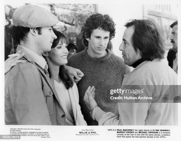 Director Paul Mazursky talks with Ray Sharkey, Margot Kidder and Michael Ontkean in a scene from the 20th Century Fox movie "Willie & Phil" circa...