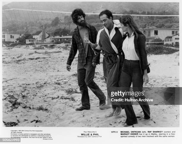 Michael Ontkean, Ray Sharkey and Margot Kidder walk on the beach in a scene from the 20th Century Fox movie "Willie & Phil" circa 1980.