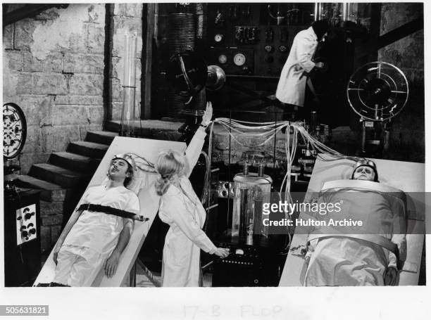 Gene Wilder lays on a table with Peter Boyle in a scene from the movie "Young Frankenstein" circa 1974.