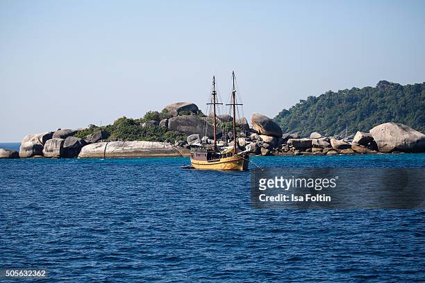Sailing boat in front of Turtle Rock of Island 9 on January 04, 2015 in Similan Islands, Thailand.