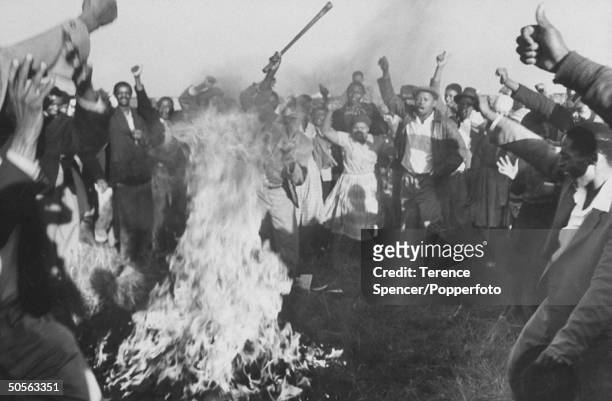 Residents from the township of Sharpeville burn their pass books during a demonstration against government pass laws as part of a day of protest at...