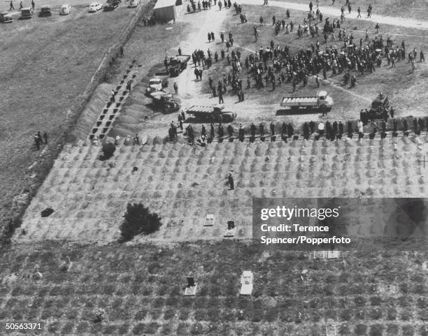 Bodies arrive on the back of flat bed trucks to be buried in a graveyard near the township of Sharpeville in Transvaal, South Africa following the...