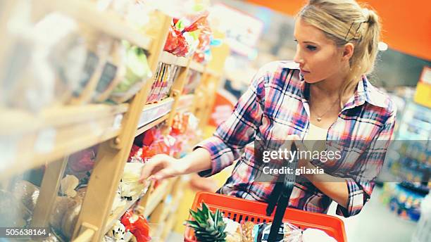 woman buying food in supermarket. - supermarket bread stock pictures, royalty-free photos & images