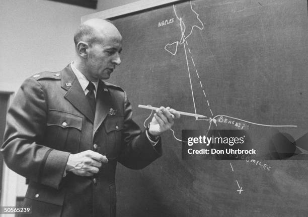 Col. Paul Fallon shows site in desert where airplane `lady be good' crashed on WW II mission, entire crew perished.