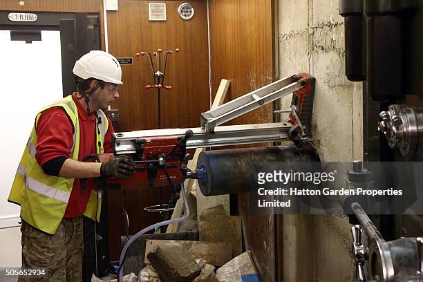 Diamond driller Sunny Kirby drills a hole in the wall used by burglars to access the underground vault of the Hatton Garden Safe Deposit Company...