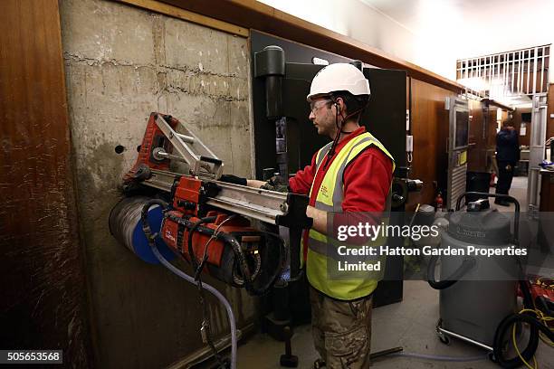 Diamond driller Sunny Kirby drills a hole in the wall used by burglars to access the underground vault of the Hatton Garden Safe Deposit Company...